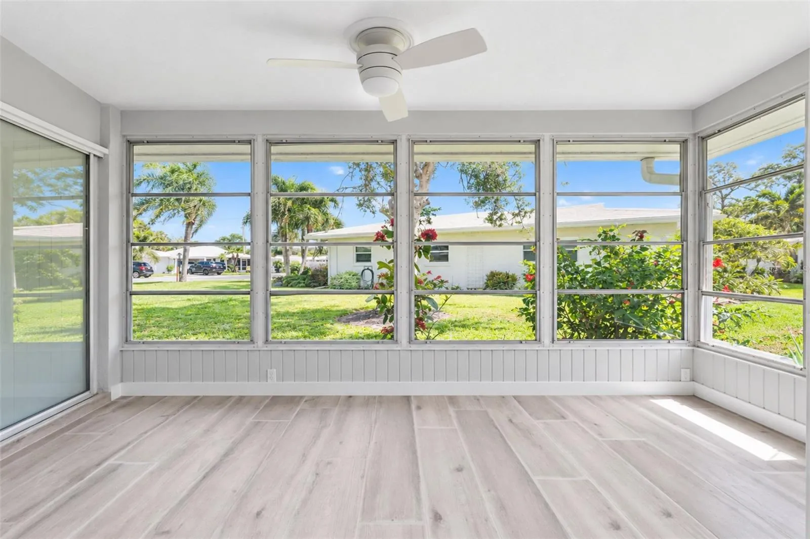 The 4 season room is surrounded in glass windows to provide natural light and beautiful breezes to enjoy Florida's beautiful weather