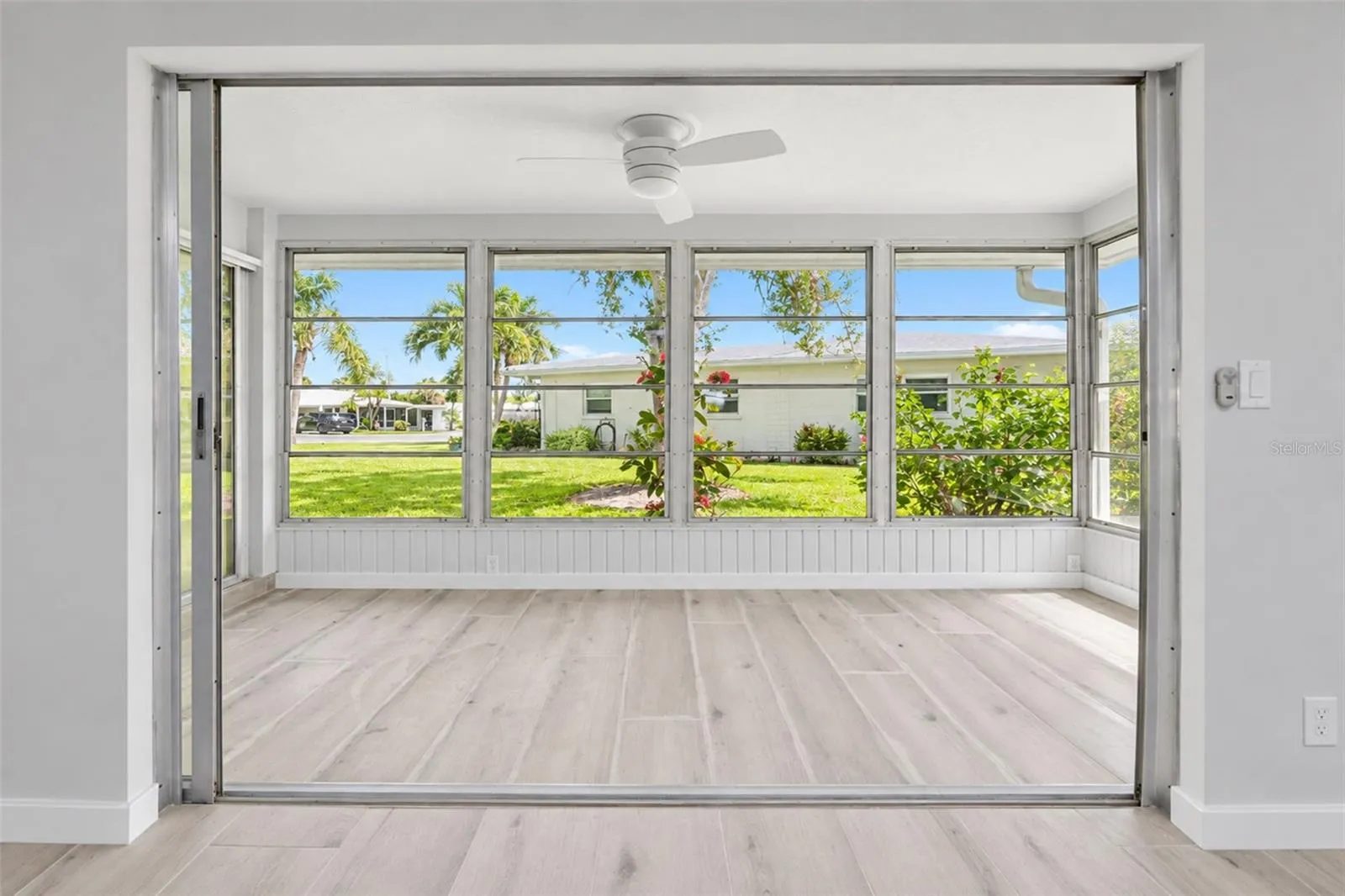 Sliding glass doors combine the living and 4 season room.