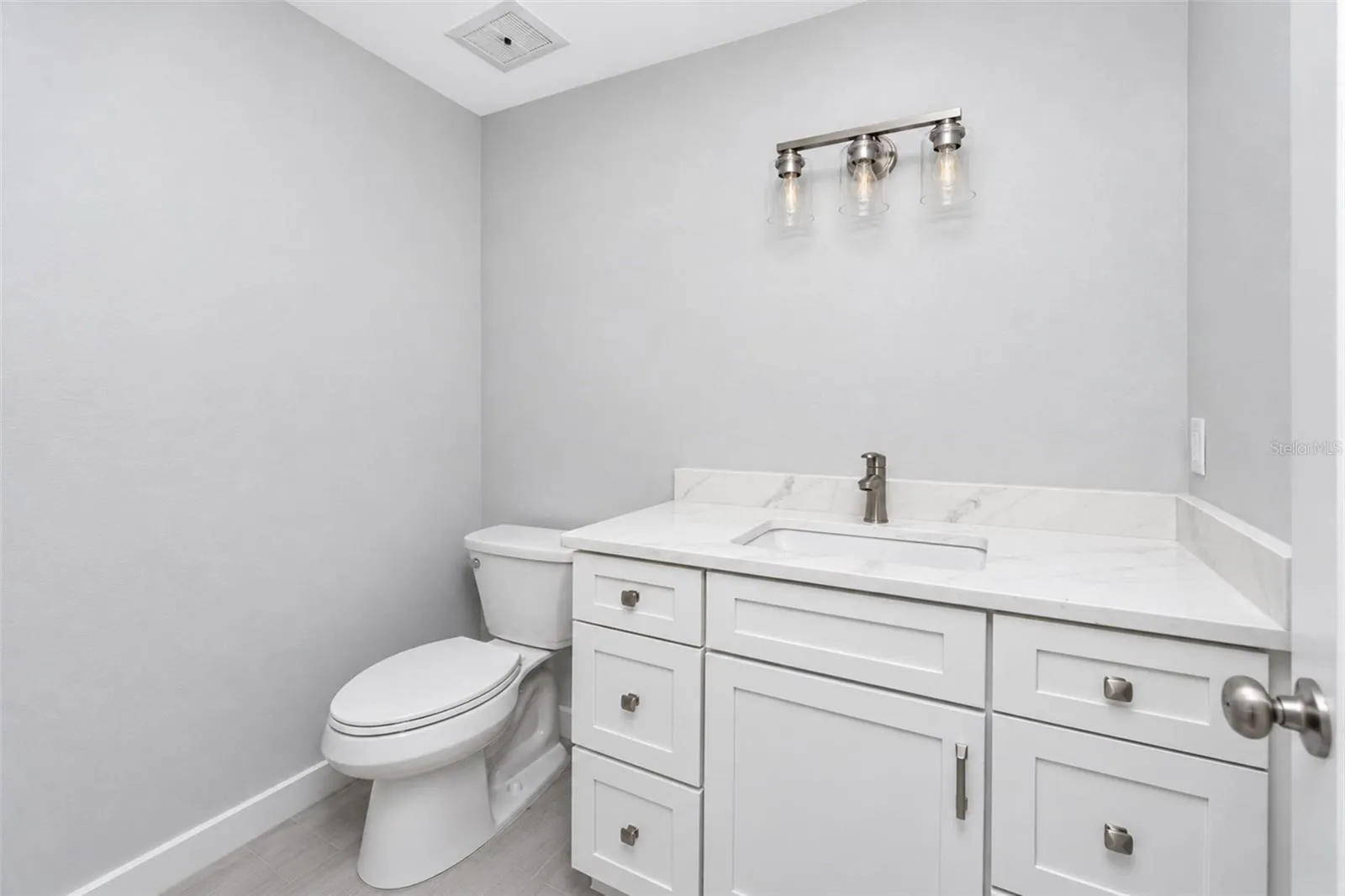 Guest Bath with new mission style cabinetry and quartz counters.
