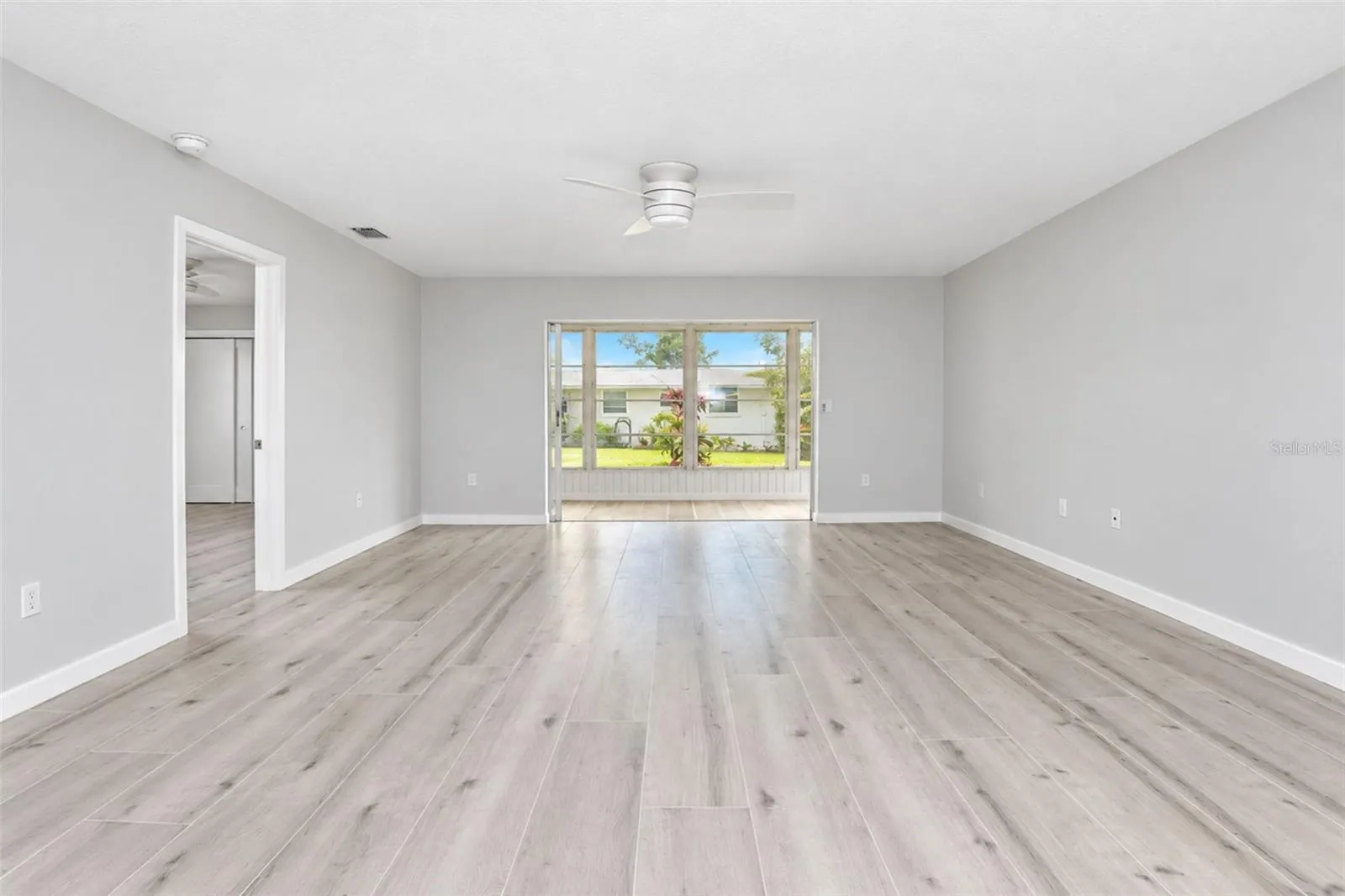 Living room is offered    lots of natural light from the 4 season porch