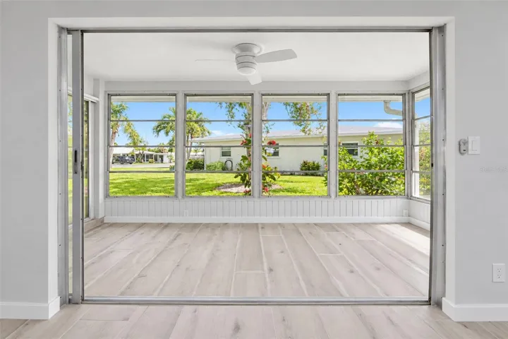Sliding glass doors combine the living and 4 season room.