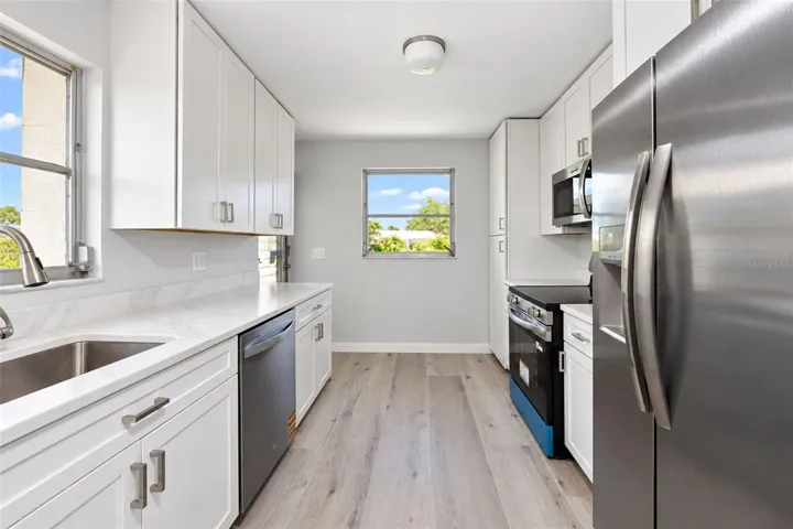 NEW Kitchen with qurtz counters an stainless steel appliance package.