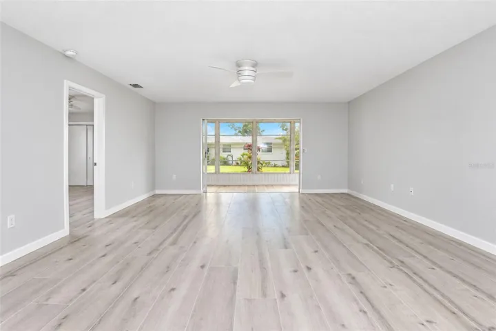 Living room is offered    lots of natural light from the 4 season porch