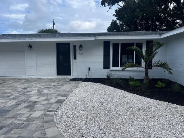 Brand new exterior including new roof and circle paver driveway