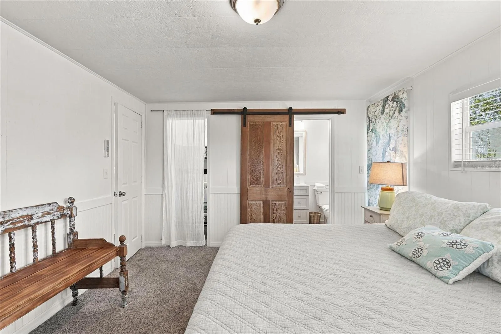 Barn door to the en-suite bathroom