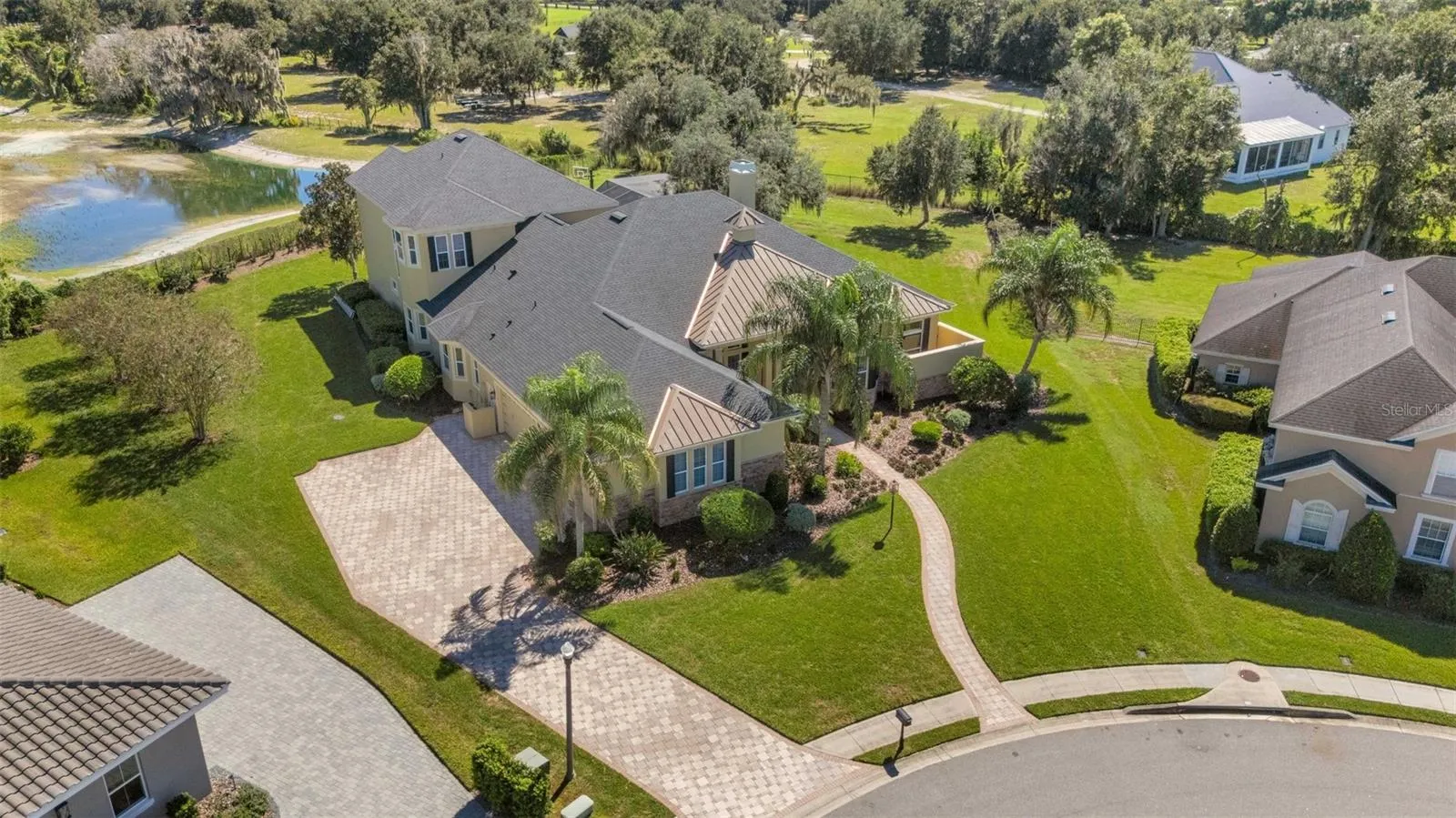 The home has a full brick paver driveway leading to a 4-car (YES, 4-CAR) garage, sidewalks and so much more.