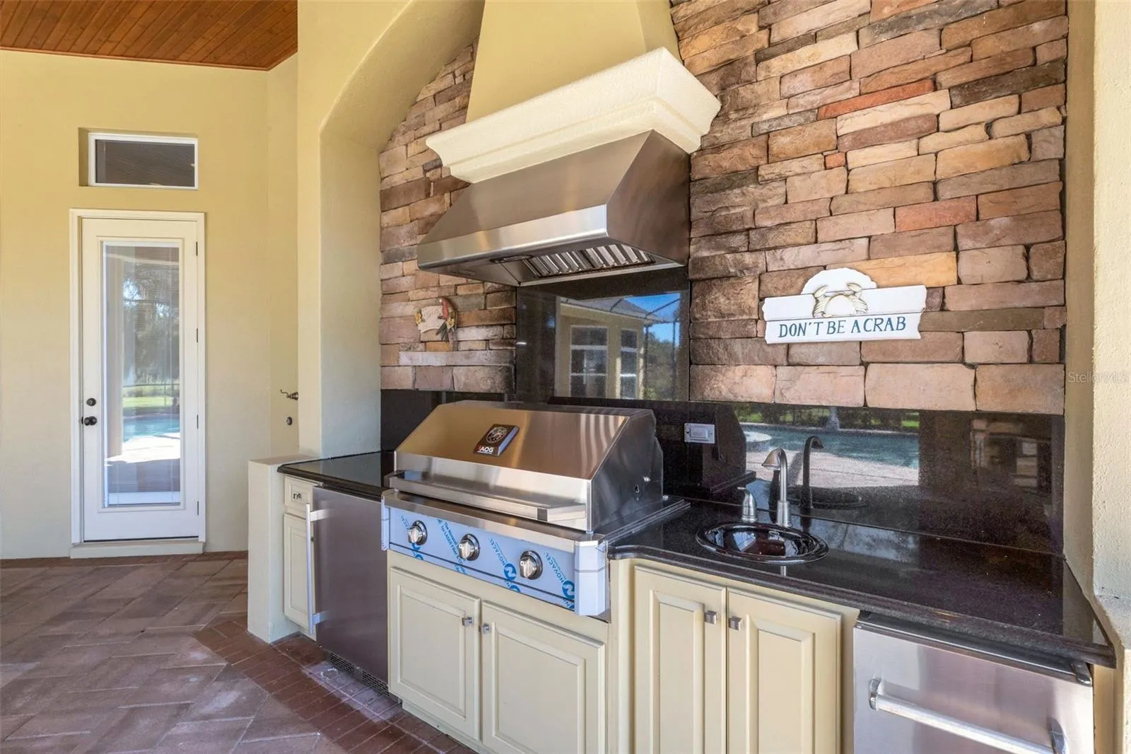 There NEW built-in gas grill, refrigerator and bar sink area.