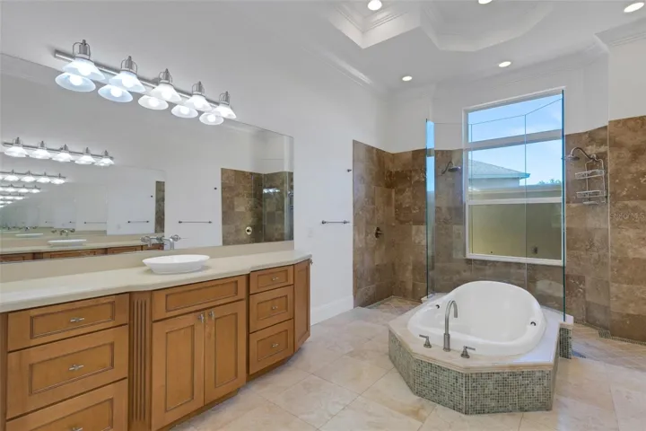The ensuite bathroom has dual long vanities with tons of storage.