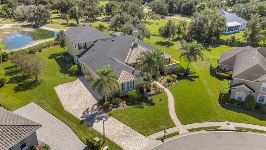 The home has a full brick paver driveway leading to a 4-car (YES, 4-CAR) garage, sidewalks and so much more.
