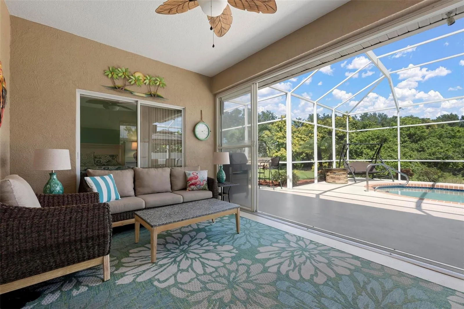 Under roof Lanai outdoor space protected from side winds and weather with sliders to close out any incliment weather.