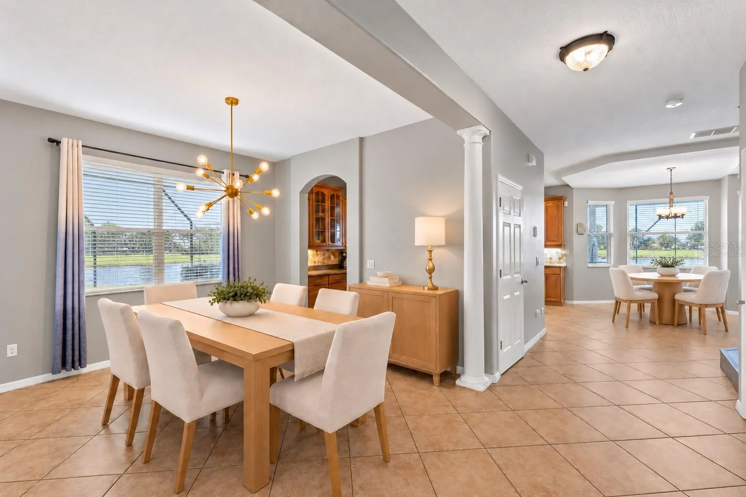 Virtually Staged: The kitchen features granite countertops, stainless steel appliances, solid wood cabinetry, a stone backsplash and pantry storage.