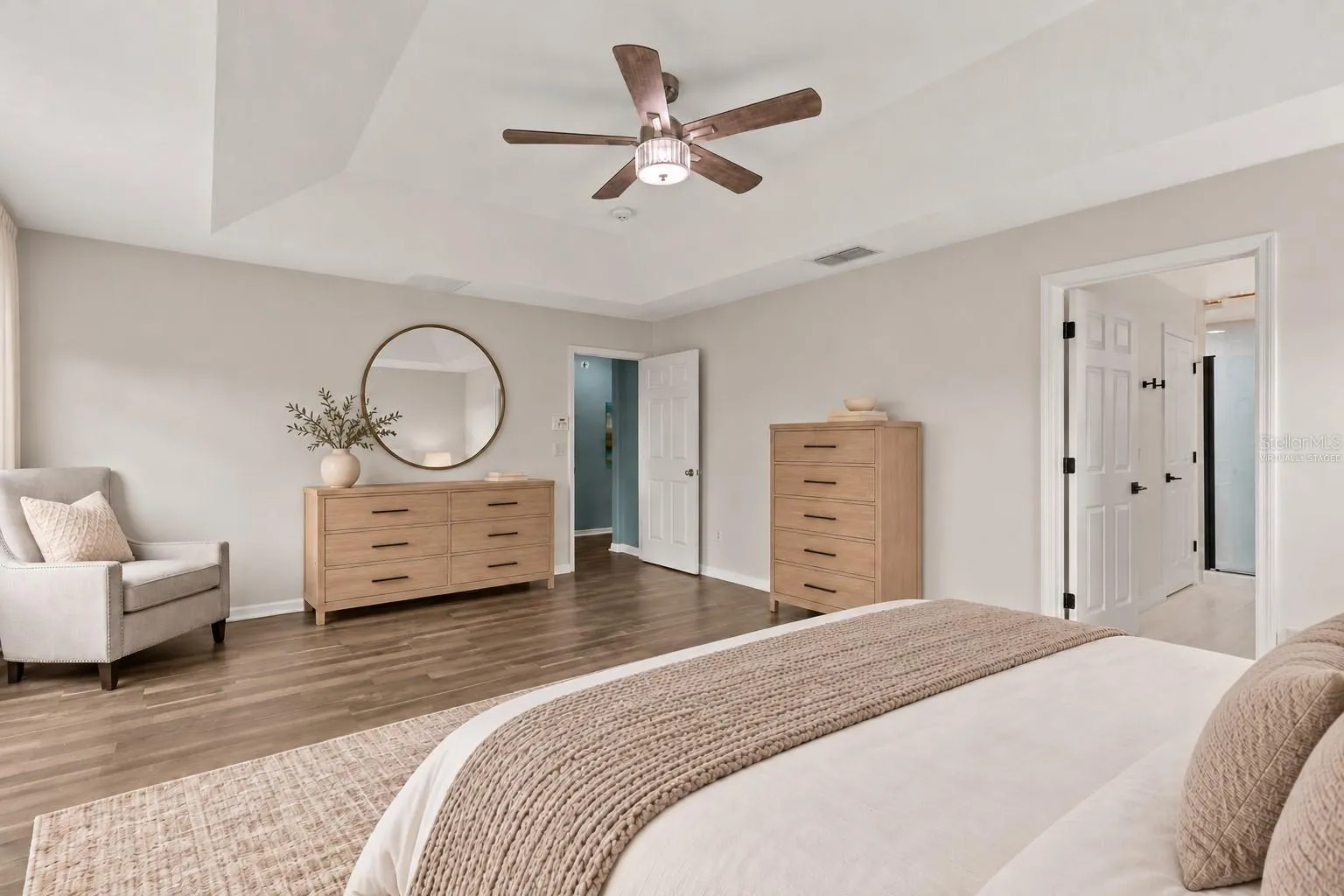 Virtually Staged: The generous primary suite features a tray ceiling and walk in closet.