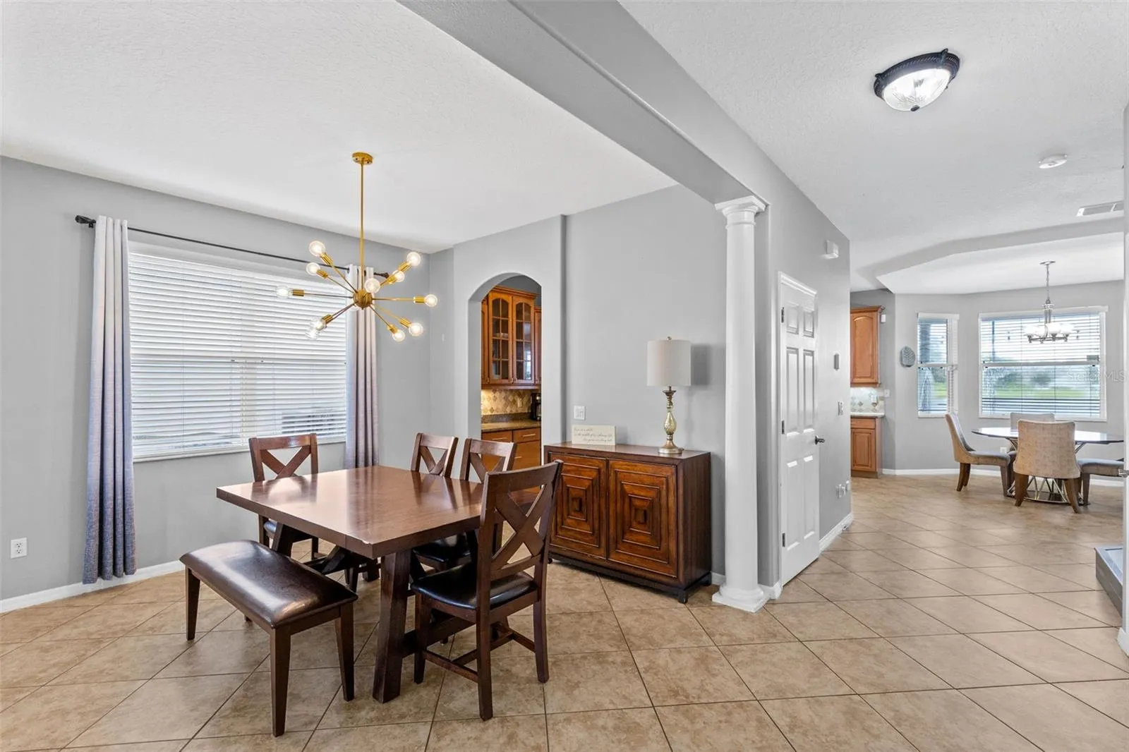 A stone fireplace creates a warm focal point in the formal living room.