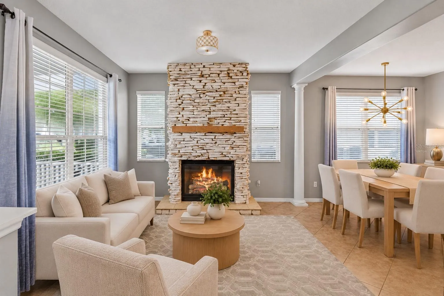 Virtually Staged: A stone fireplace creates a warm focal point in the formal living room.