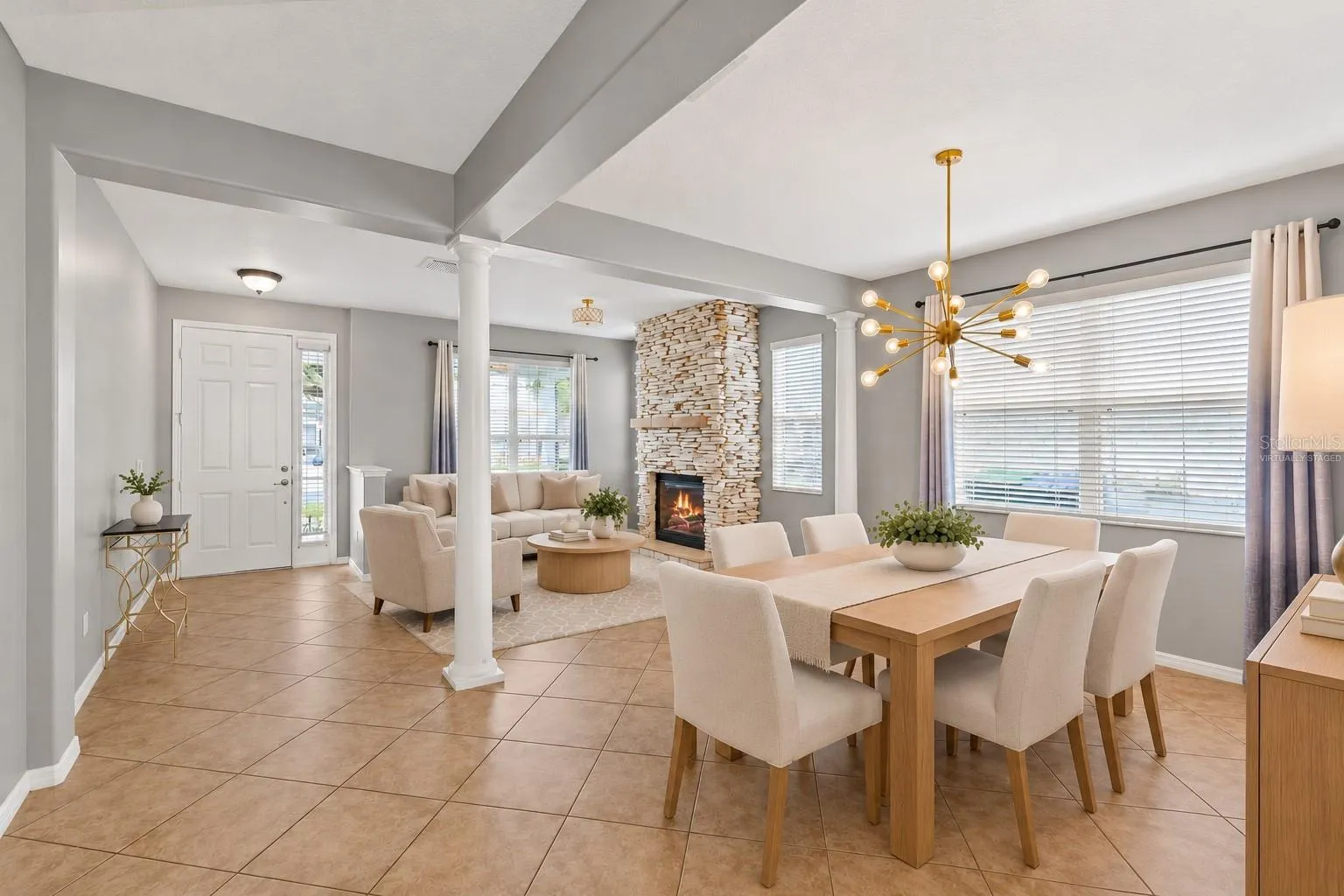 Virtually Staged: A stone fireplace creates a warm focal point in the formal living room.