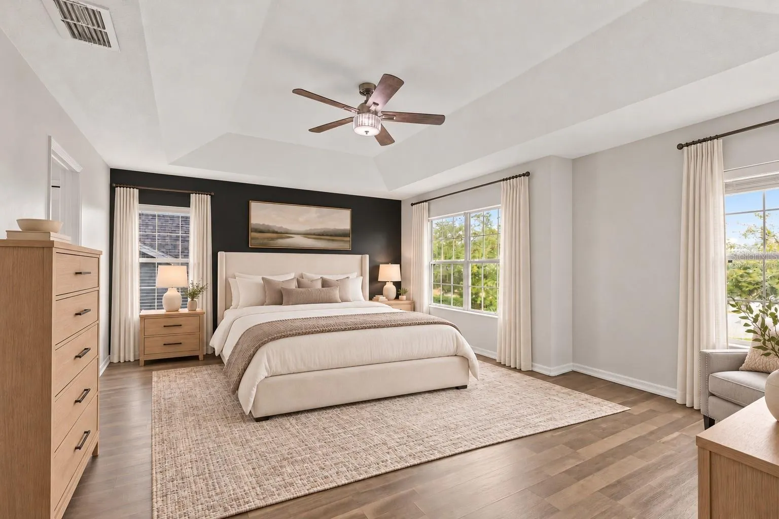 Virtually Staged: The generous primary suite features a tray ceiling and walk in closet.