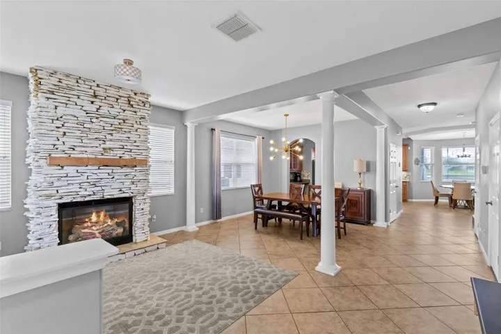 A stone fireplace creates a warm focal point in the formal living room.