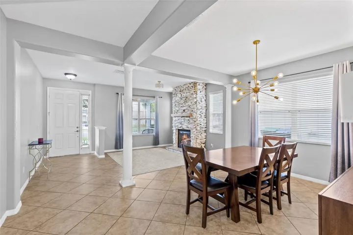 A stone fireplace creates a warm focal point in the formal living room.