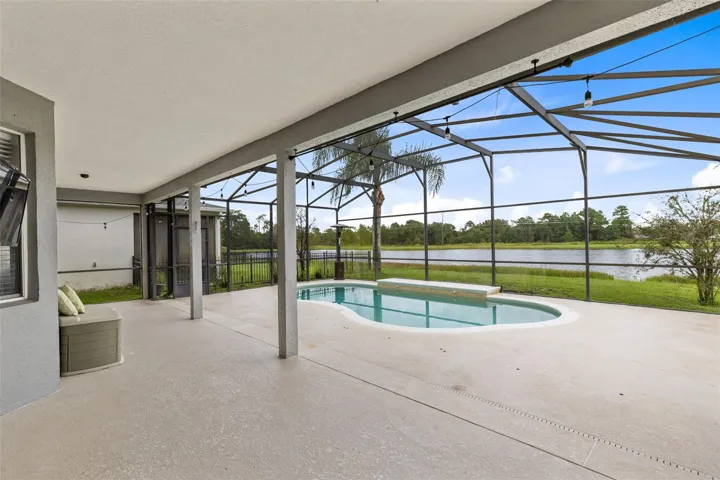 Outside, the covered lanai and screened pool overlook the pond, creating a peaceful setting with no immediate rear neighbors. The outdoor space also includes a built in grill and partially fenced backyard.