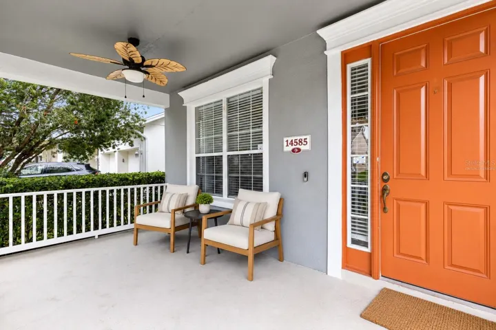 Virtually Staged: A covered front porch welcomes you into the foyer, where the formal living and dining rooms are positioned together just inside the entrance.
