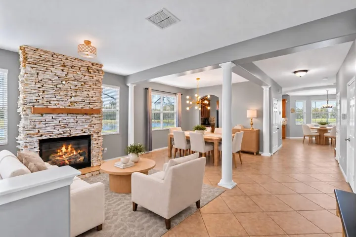Virtually Staged: A stone fireplace creates a warm focal point in the formal living room.
