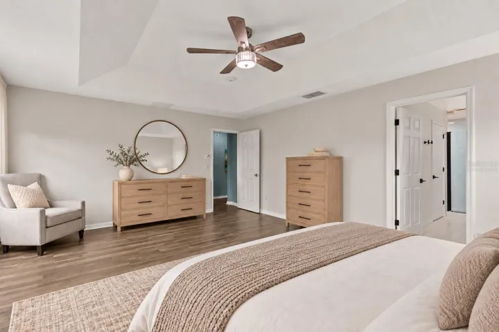 Virtually Staged: The generous primary suite features a tray ceiling and walk in closet.