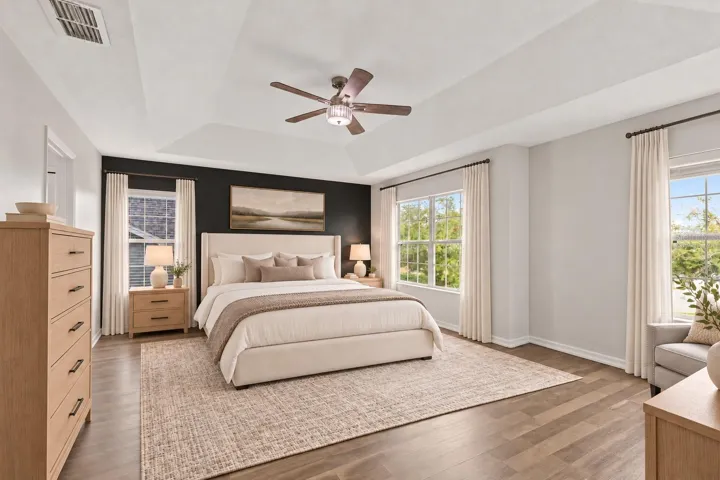 Virtually Staged: The generous primary suite features a tray ceiling and walk in closet.