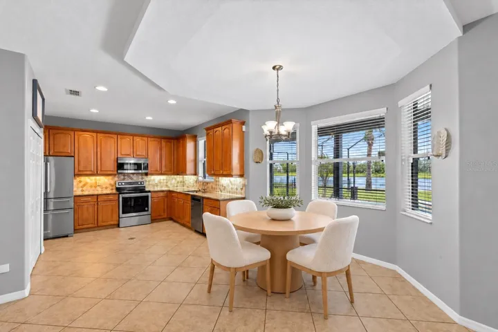 Virtually Staged: The kitchen features granite countertops, stainless steel appliances, solid wood cabinetry, a stone backsplash and pantry storage.