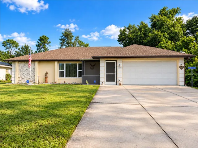 Front Exterior | Welcome to 23088 Gray Ave, a well maintained Port Charlotte home with a 2023 roof and two car garage.
