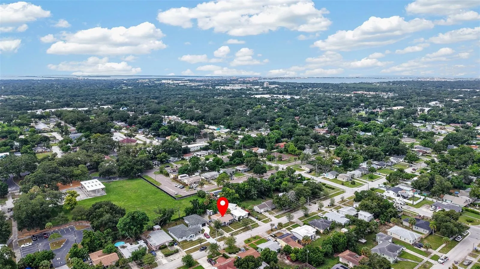 Aerial view of property and surrounding neighborhood the property location is marked with a red pin