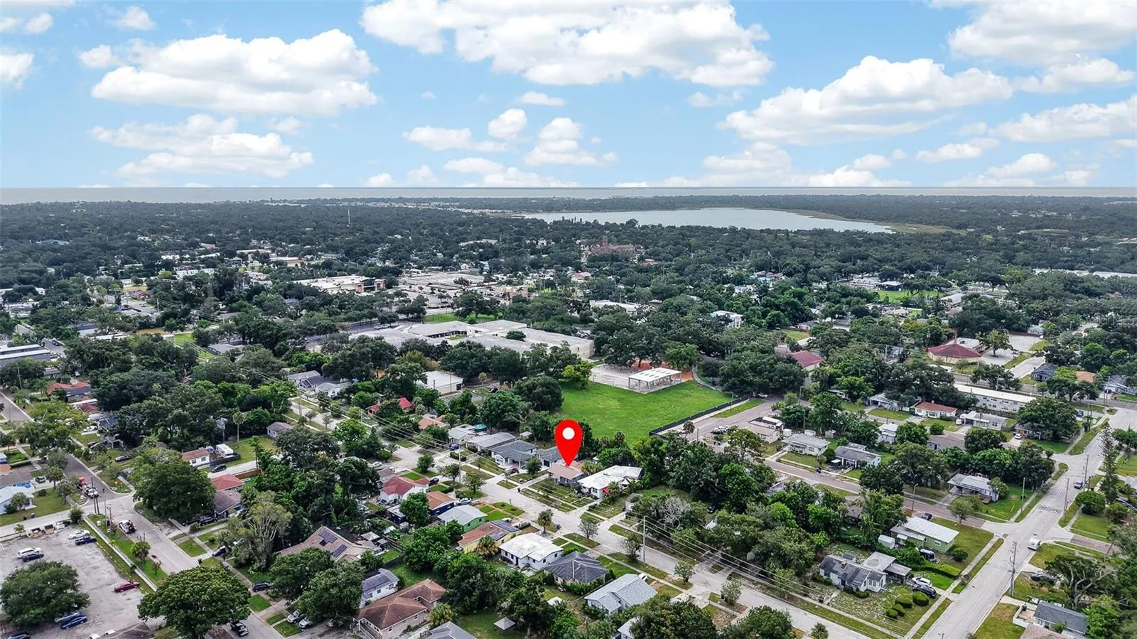 Aerial view of property and surrounding neighborhood the property location is marked with a red pin
