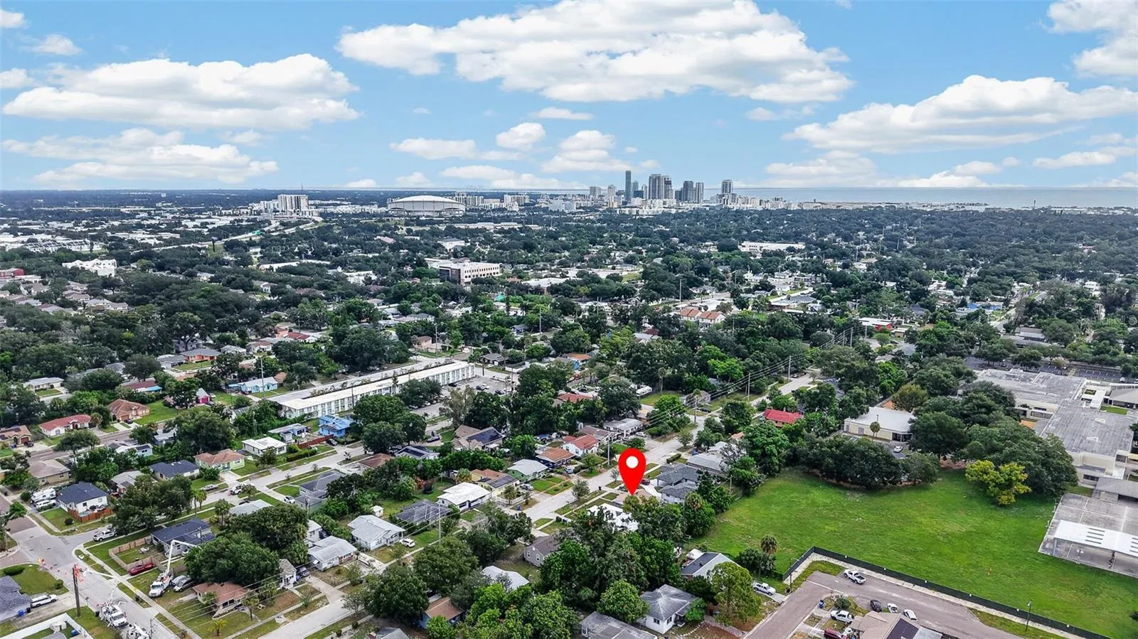 Aerial view of property and surrounding neighborhood the property location is marked with a red pin