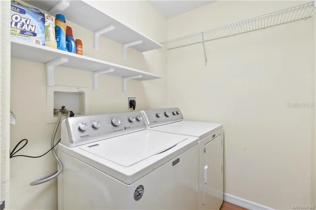 Indoor Laundry Room – Dedicated laundry area with washer and dryer, shelving and additional storage space.