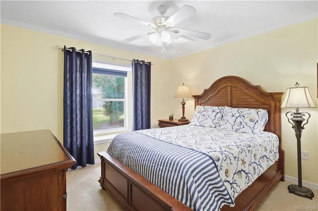 Guest Bedroom – Comfortable guest bedroom with crown molding, ceiling fan and natural light.