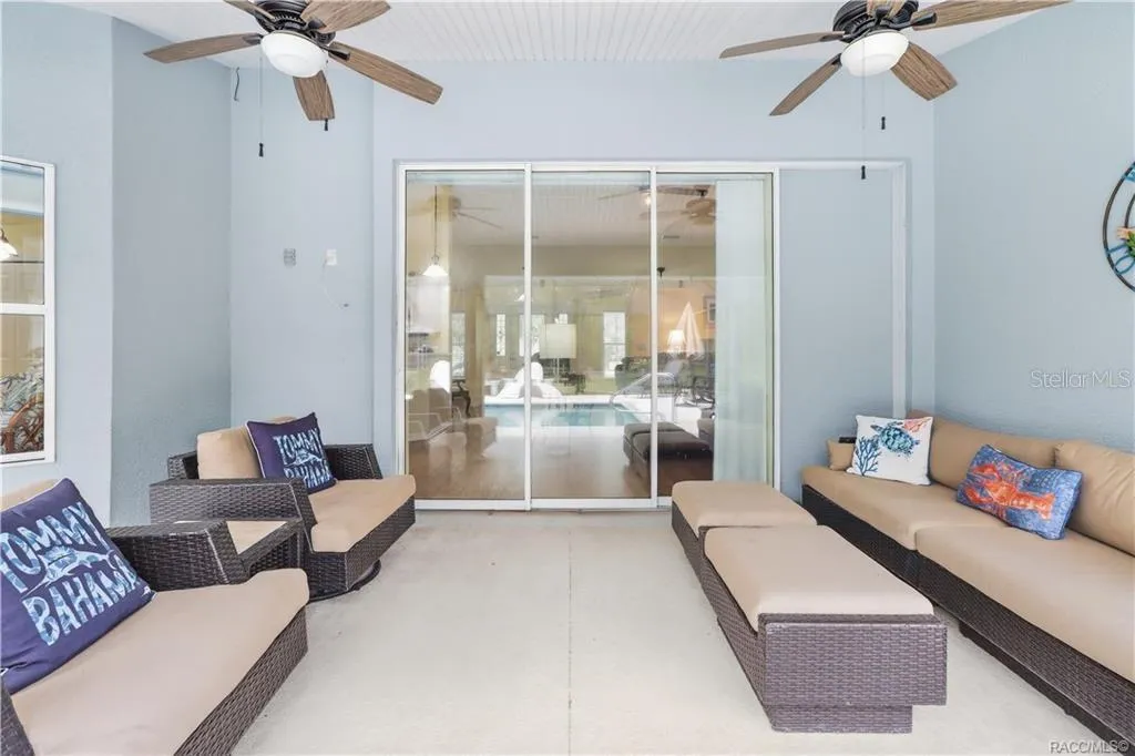 Covered Lanai – Additional view highlighting the generous covered entertaining space and direct access to the home and pool area.