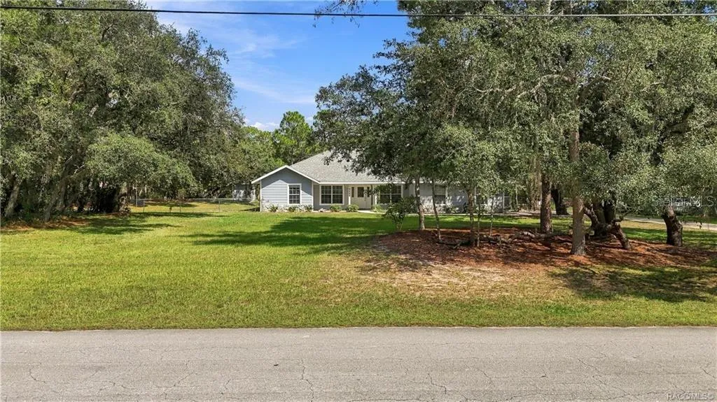 SPACE &amp; PRIVACY FROM THE STREET – Wide front yard with mature trees creating a naturally buffered setting.
