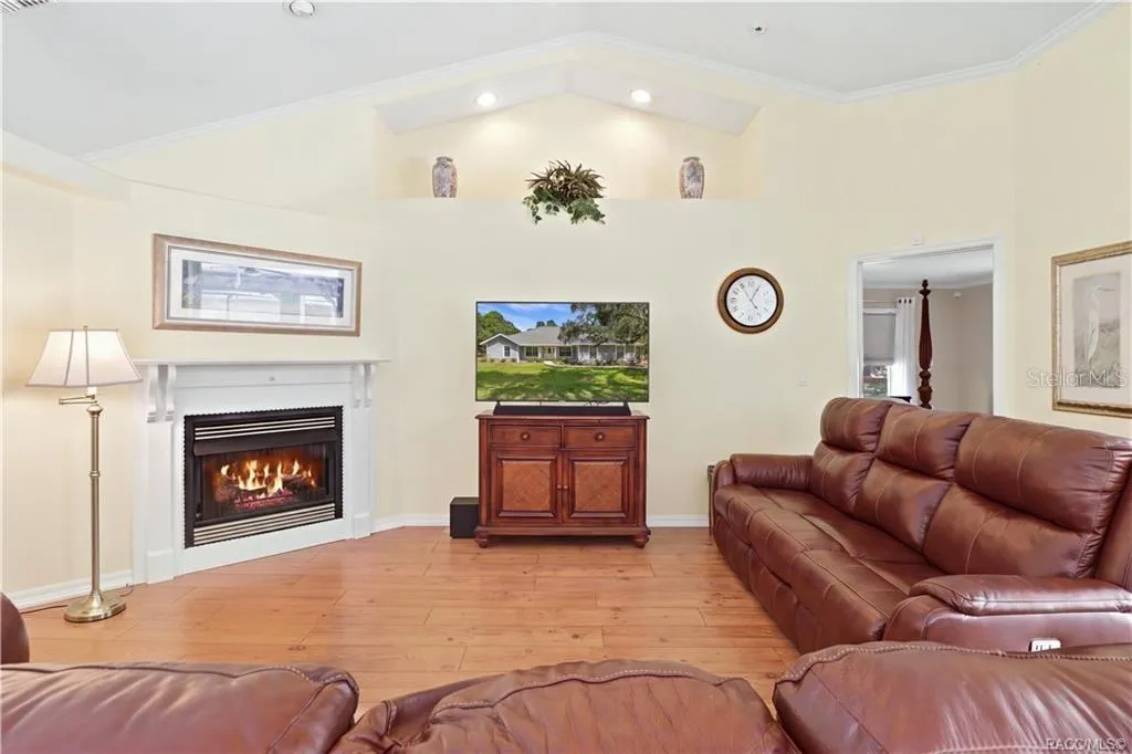 Living Room with GAS Fireplace – Inviting living room featuring a gas fireplace, vaulted ceiling, architectural display ledge, recessed lighting &amp; crown molding. (Gas for the fireplace is not hooked up).