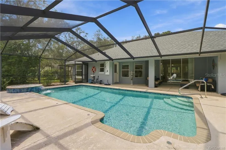 YOUR OWN BACKYARD RETREAT – Large screened pool with generous deck space, covered patio &amp; raised water feature.