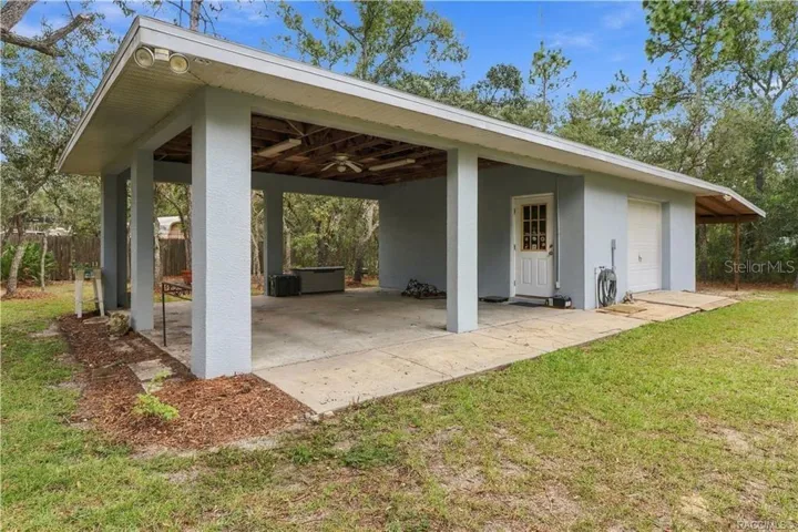 DETACHED 20x20 GARAGE + 2 COVERED CARPORTS + POLE BARN– Versatile detached garage/workshop with an oversized covered area for additional parking, equipment or outdoor projects. BRING YOUR TOYS!