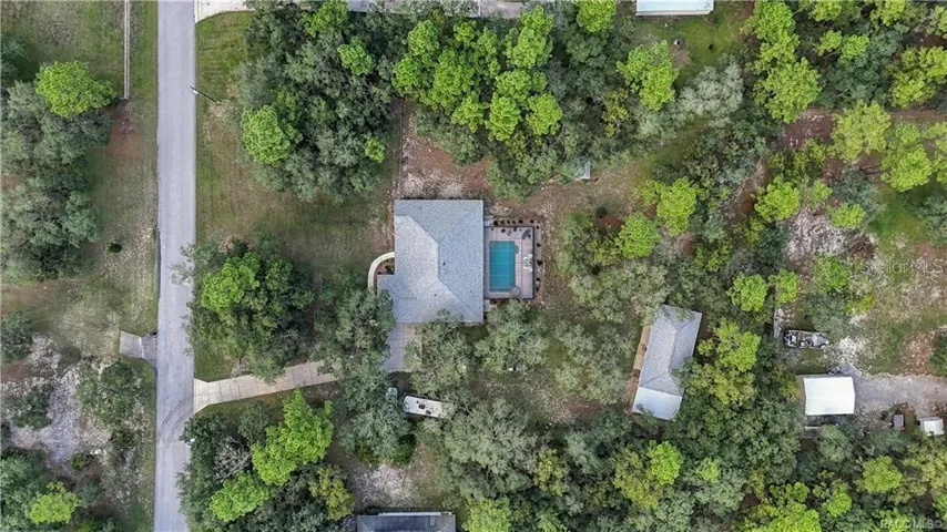 SPACE YOU CAN REALLY SEE – Overhead aerial highlights the home, pool, detached garage and generous homesite.