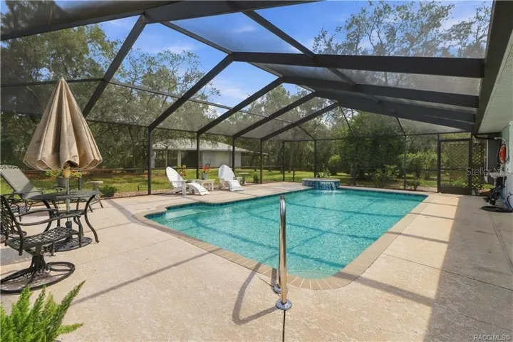 SPACIOUS SCREEN-ENCLOSED POOL – Expansive pool and deck area with plenty of room for swimming, lounging &amp; entertaining.