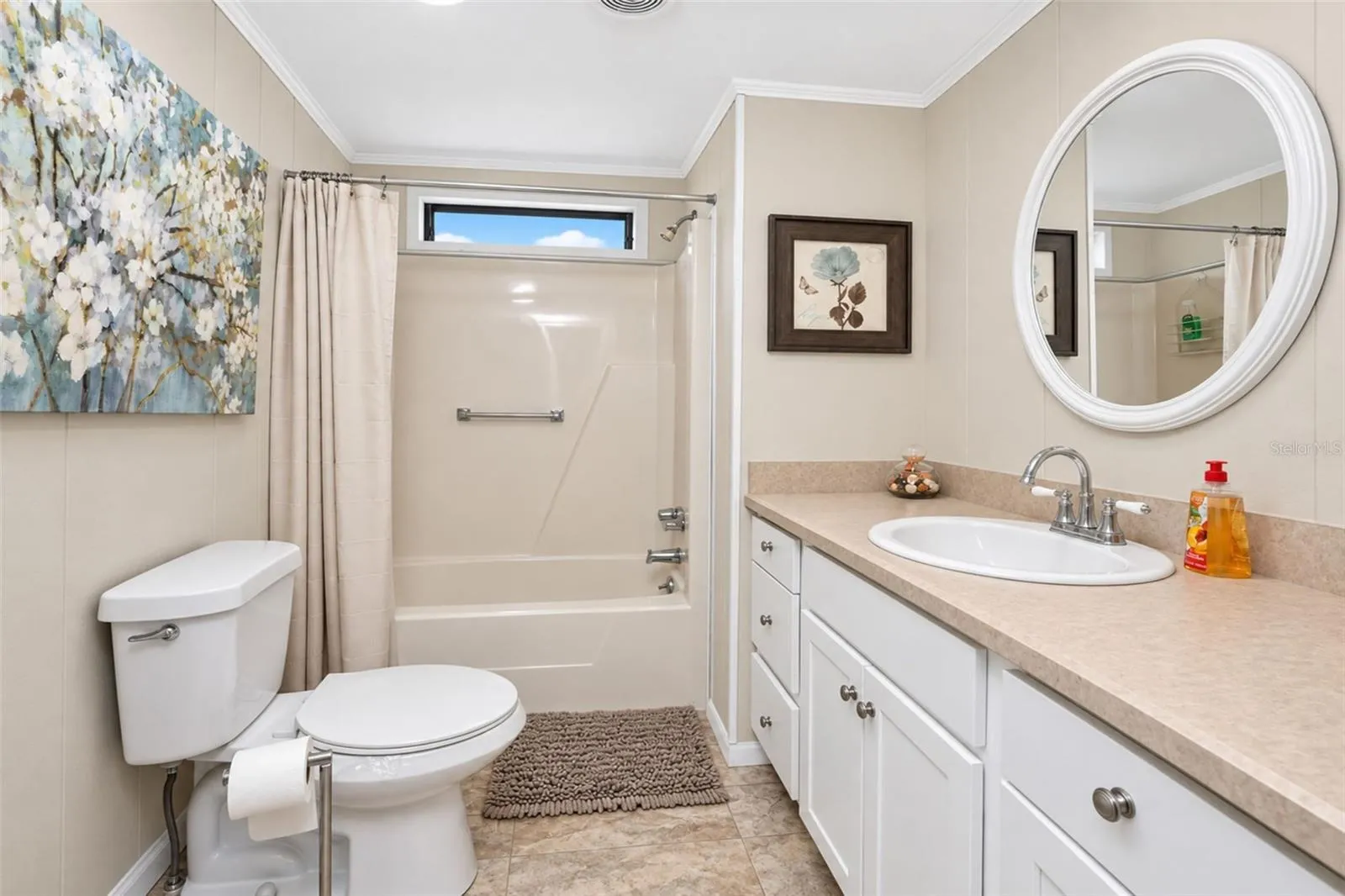 The guest bathroom features a combination tub/shower and a new toilet.