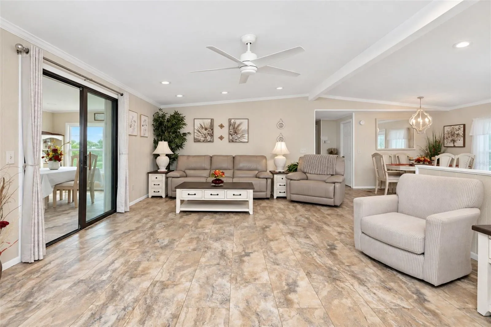 The living and dining area are enhanced by the crown moulding, cathedral ceiling and recessed lighting.