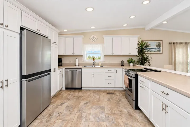 The kitchen features a Whirlpool French door refrigerator, Samsung dishwasher and Frigidaire smooth top stove.