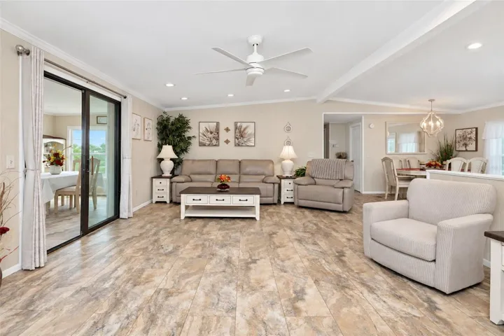 The living and dining area are enhanced by the crown moulding, cathedral ceiling and recessed lighting.