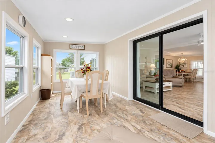 The Florida room is air conditioned, features impact-glass windows and the same LVP flooring as throughout the home.