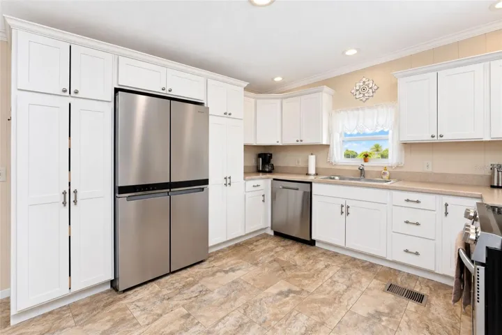 The kitchen features raised-panel cottage style cabinetry with soft close doors and pull out doors.