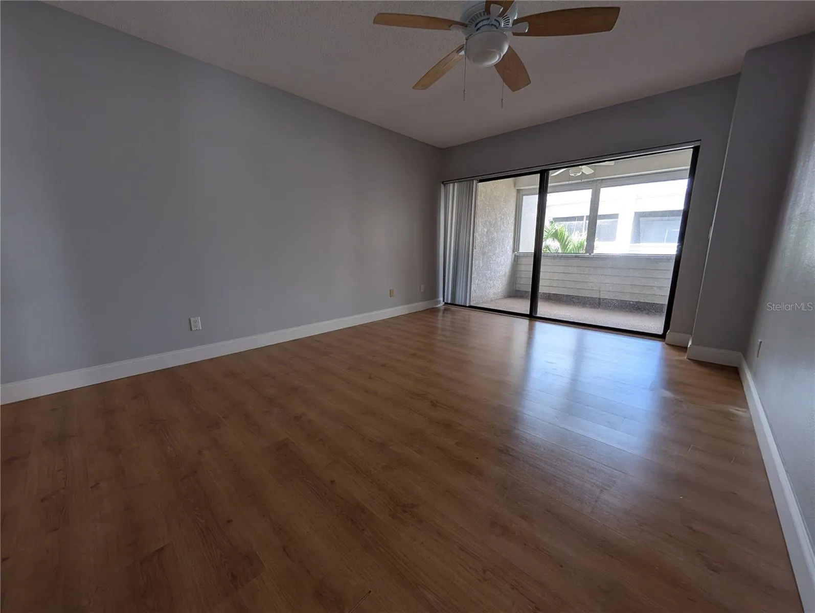 Primary bedroom with slider to screened patio