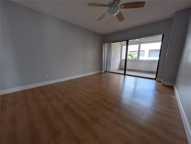 Primary bedroom with slider to screened patio