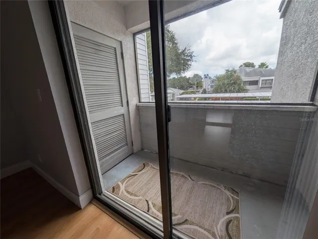 2nd bedroom with slider to private patio and outdoor storage closet